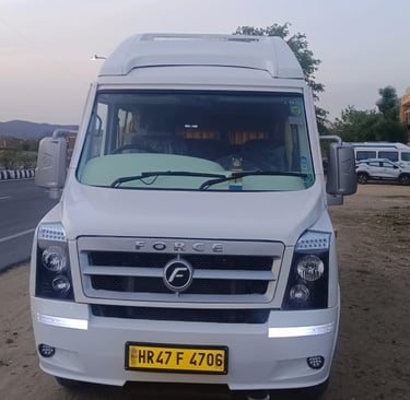 a Forc trmpo traveler parked on the side of a road