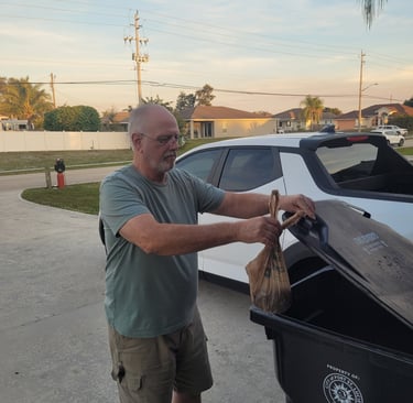Robert placing dog waste in trash bin in psl