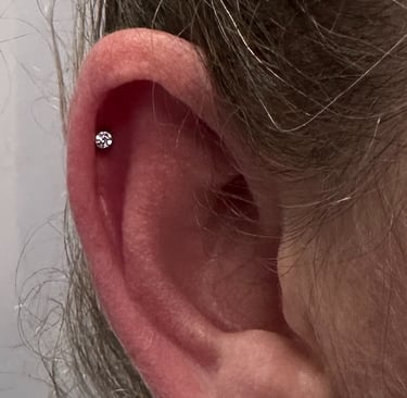 Licensed helix piercing with titanium jewellery in Stonehaven studio