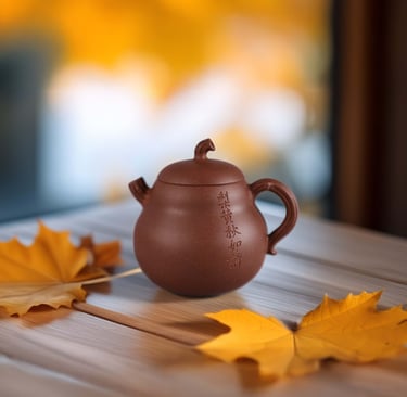 A carved teapot placed on a wooden table, accompanied by a maple leaf