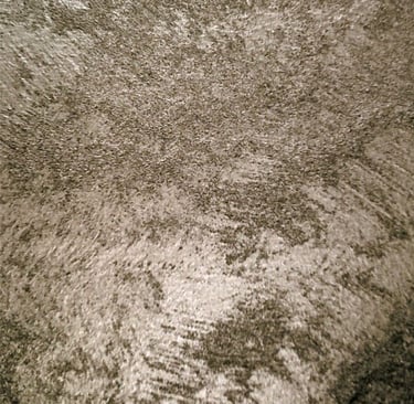 A warm silver paint sample showing its lustre and beautiful grainy texture.