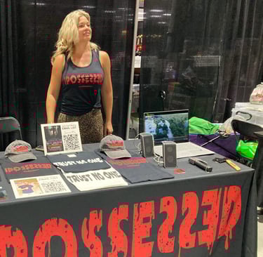 a woman standing in front of a table with a sign that says possy