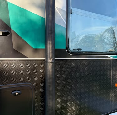 Durable awning arm covers protecting caravan hardware from road grime