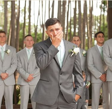 Emotional groom seeing bride for the first time