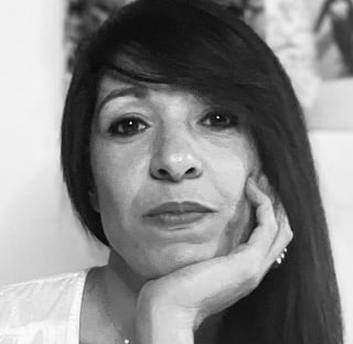 a woman with long hair and a white shirt