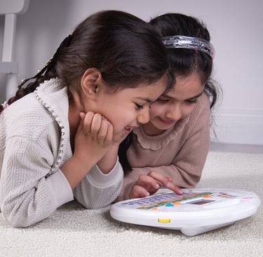 2 girls using the Quran reader by Desi Doll