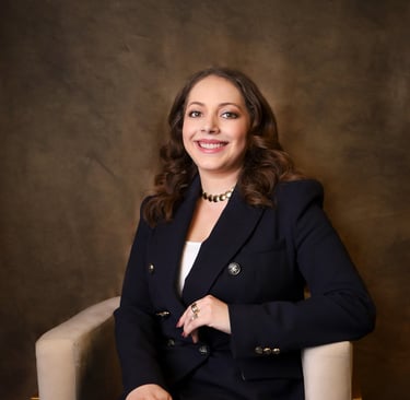 a woman in a suit and a necklace