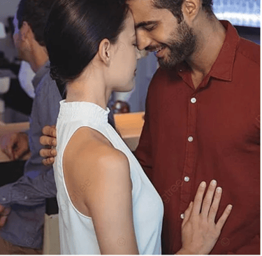 a man and woman in a bar with a man kissing Martin PE / COACH