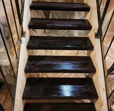 a staircase cased in a plastic bag stained wood stairs
