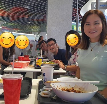 a group of Japanese people sitting at a table with smiley faces