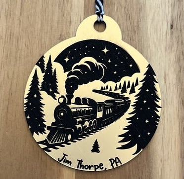 laser engraved acrylic ornament of steam train in winter