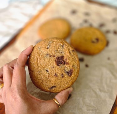 a person holding a cookie cookie cookie on a table