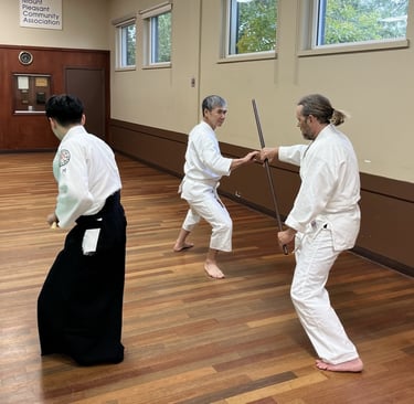 students practicing with staffs