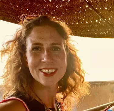 Kat Kojic, a smiling woman with shoulder length curly hair