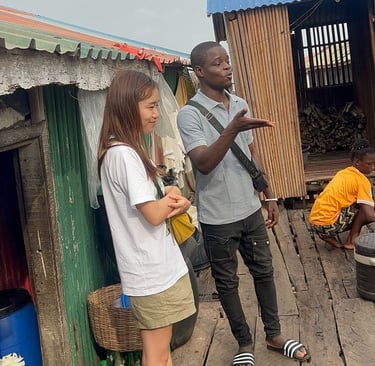 Dahomey African Tours Guide leading Tourists in Ganvie Stilt Village in Benin