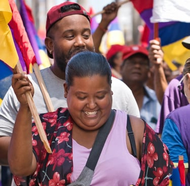 Smiling family in the crowd holding flags