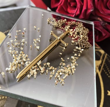 a gold sword accessory on a table