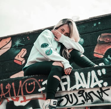 Solo traveler exploring sitting and surrounded by street art in Medellín, Colombia