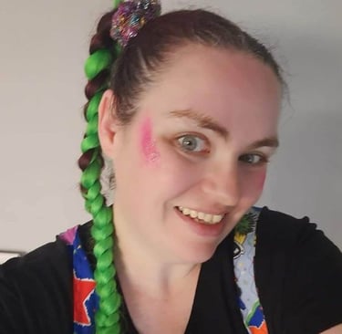 a woman with green hair and pink makeup