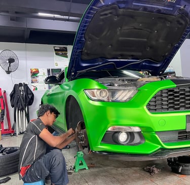 a man working on a car in a garage