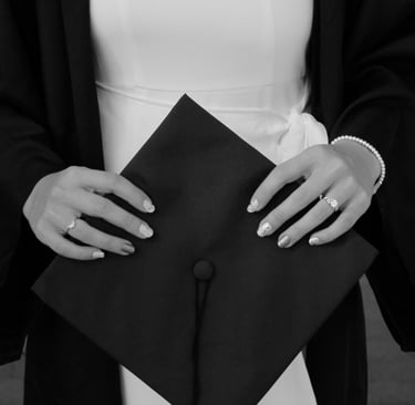 Close-up photo of hands holding a graduation cap