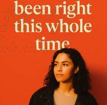a woman with curly hair and a black jacket
