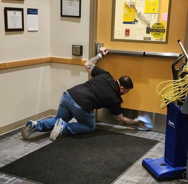 Staff member kneeling down cleaning