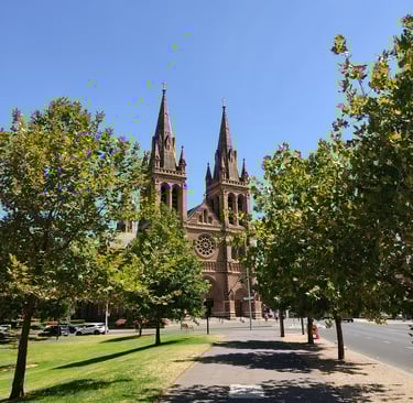 cobblestone church in the city centre of Adelaide with green trees and sunny day 