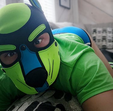 A man posing in his pup mask.
