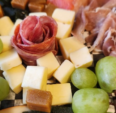 a plate of cheese and grapes on a plate