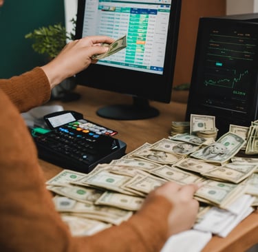 a woman sitting at a desk with money