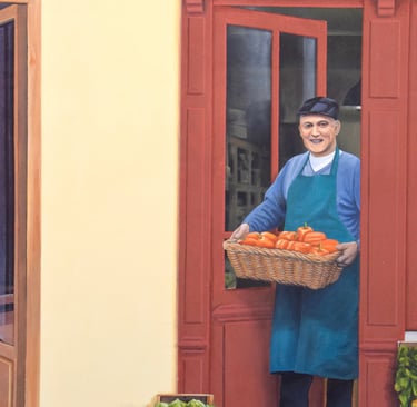 Peinture en trompe-l'oeil sur une façade: un maraîcher sort de son magasin avec un panier de légumes