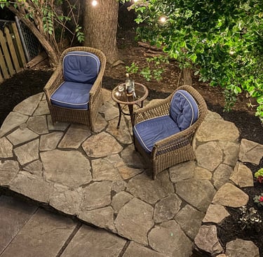 Cozy irregular field stone patio with outdoor lighting