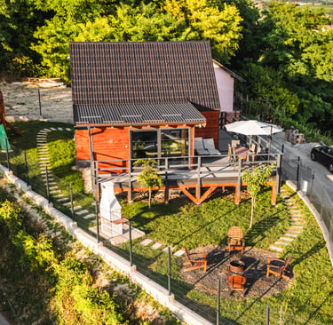 a wooden house with yard and fire pit