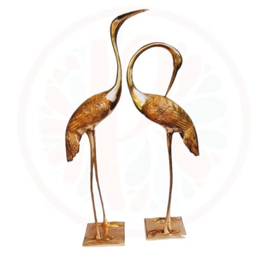 two large bronze colored birds on a stand