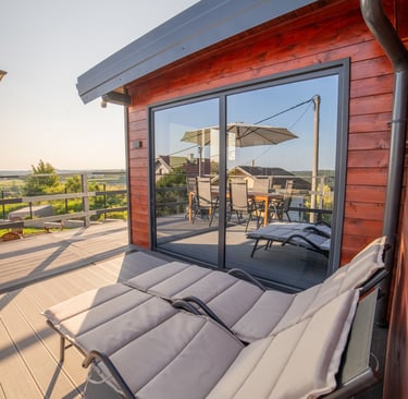 a wooden deck with a chair and a table