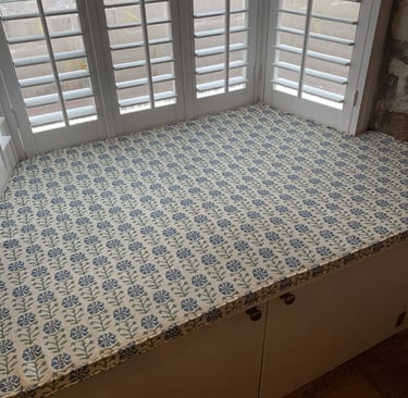 A bespoke window seat cushion shaped to fit an awkward space.