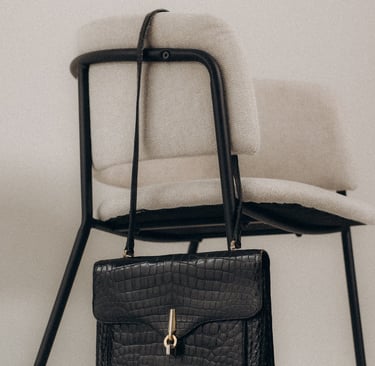 a chair with a purse and a purse bag