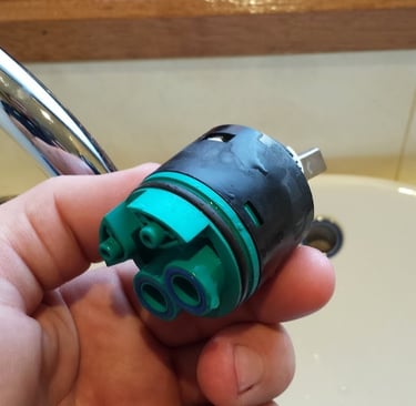 Old mixer cartridge about to be replaced