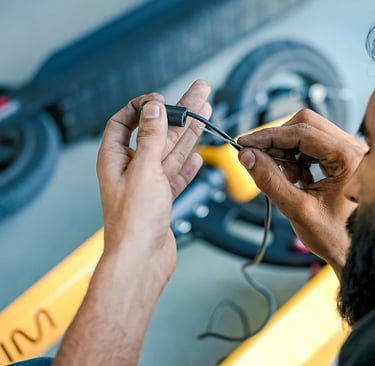 a man in a helmet is working on a piece of equipment