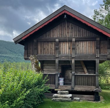 A wooden building, stabbur, with hills in the background-Telelaget