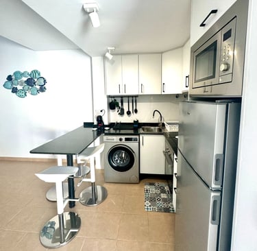 a kitchen with a washing machine and a washing machine