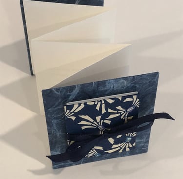 Accordion with Japanese paper and small accordion on cover, ribbon detail
