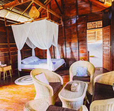 Toska bungalow bedroom with canopy bed, wooden walls, and natural light