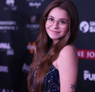 a woman with glasses and a tattoo on her arm