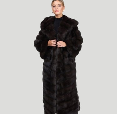 a woman in a long black gorski coat with a long coat