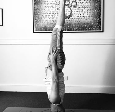a man doing a headstand yoga pose