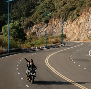 a man riding a motorcycle down a road