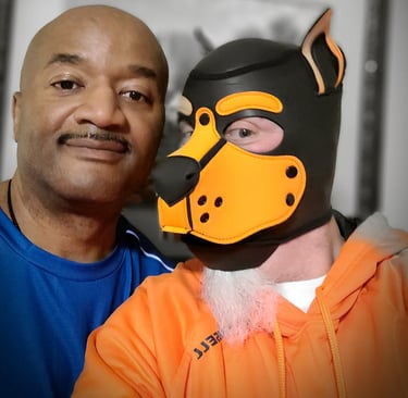 2 men - 1 in a pup mask, posing together