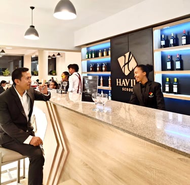 a man in a suit and tie is sitting at a bar